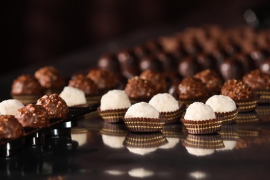 Photo of Many delicious chocolate candies on table. Production line