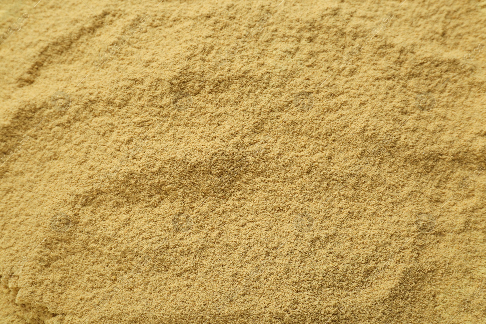 Photo of Aromatic mustard powder as background, top view