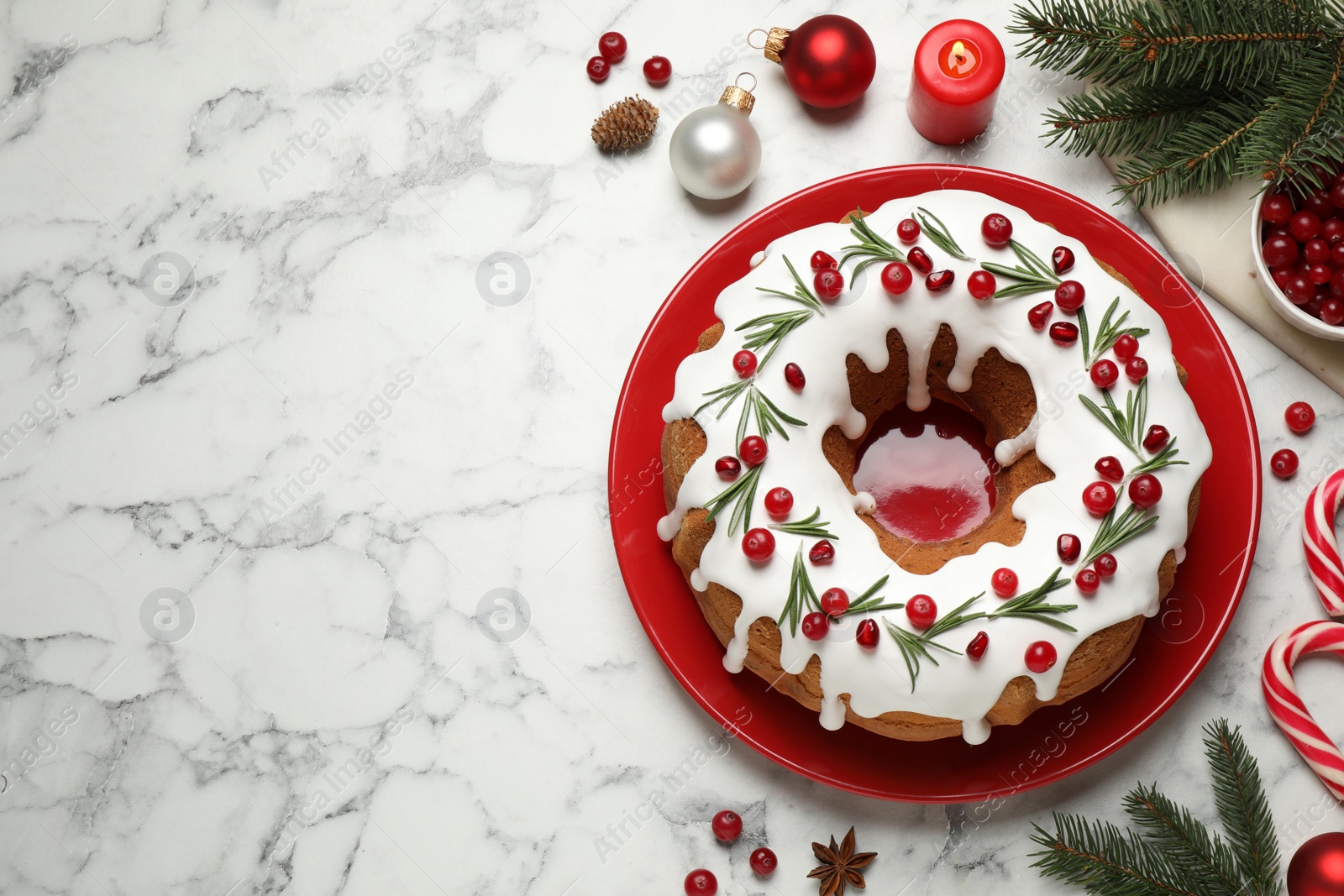 Photo of Flat lay composition with traditional homemade Christmas cake on white marble table, space for text