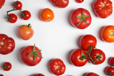 Photo of Frame of different ripe tomatoes on white background. Space for text