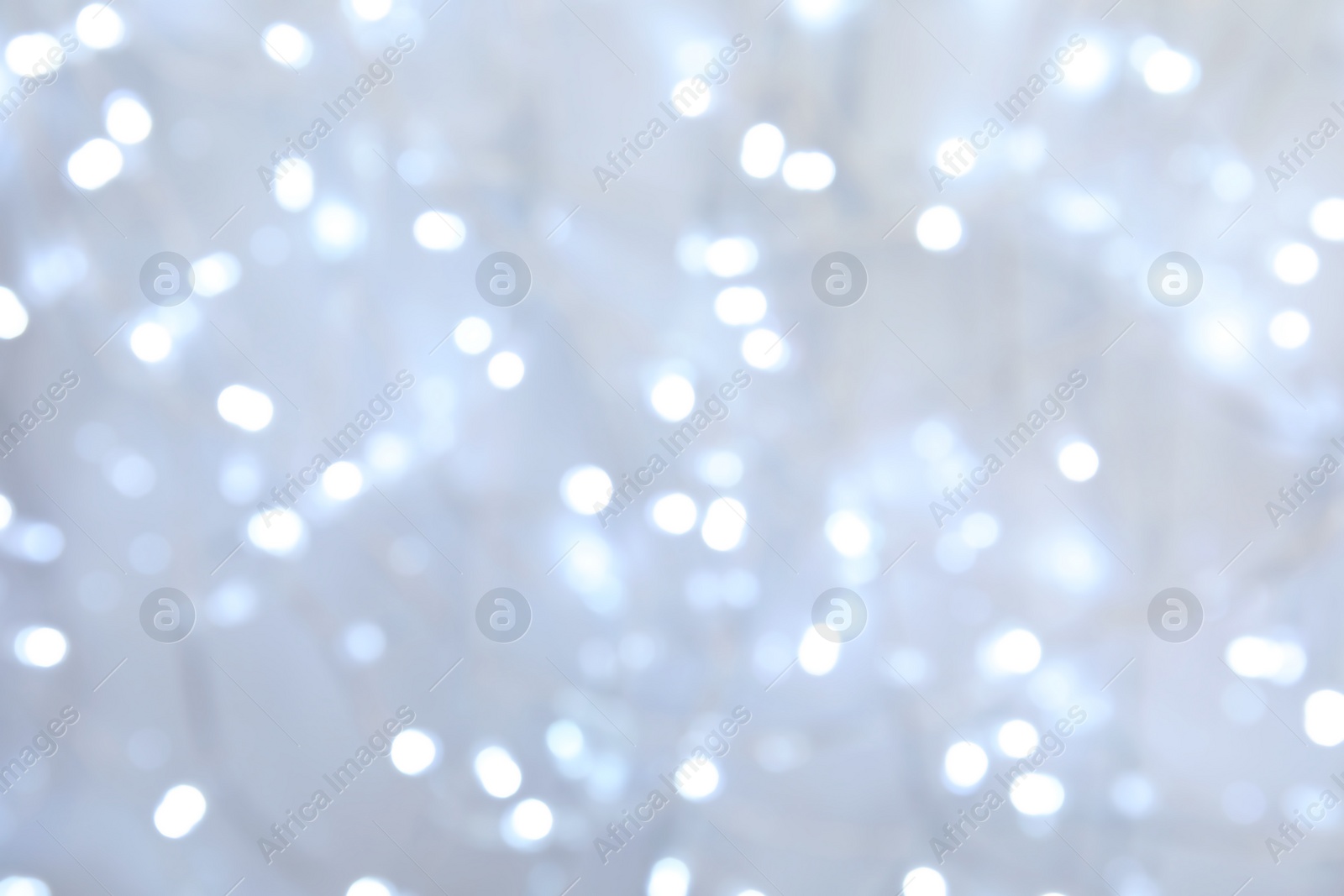 Photo of Blurred view of glowing Christmas lights as background