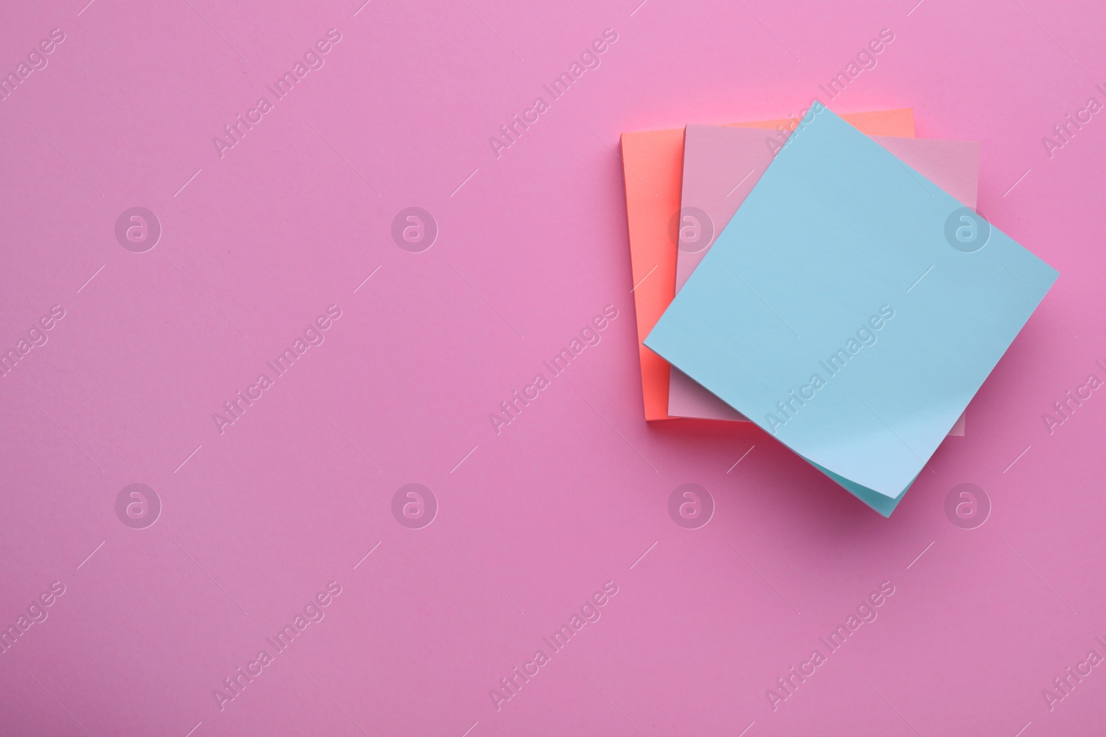 Photo of Paper notes on pale pink background, top view. Space for text