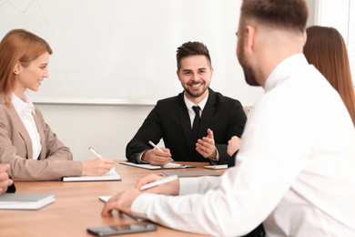 Photo of Professional business trainer working with people in office