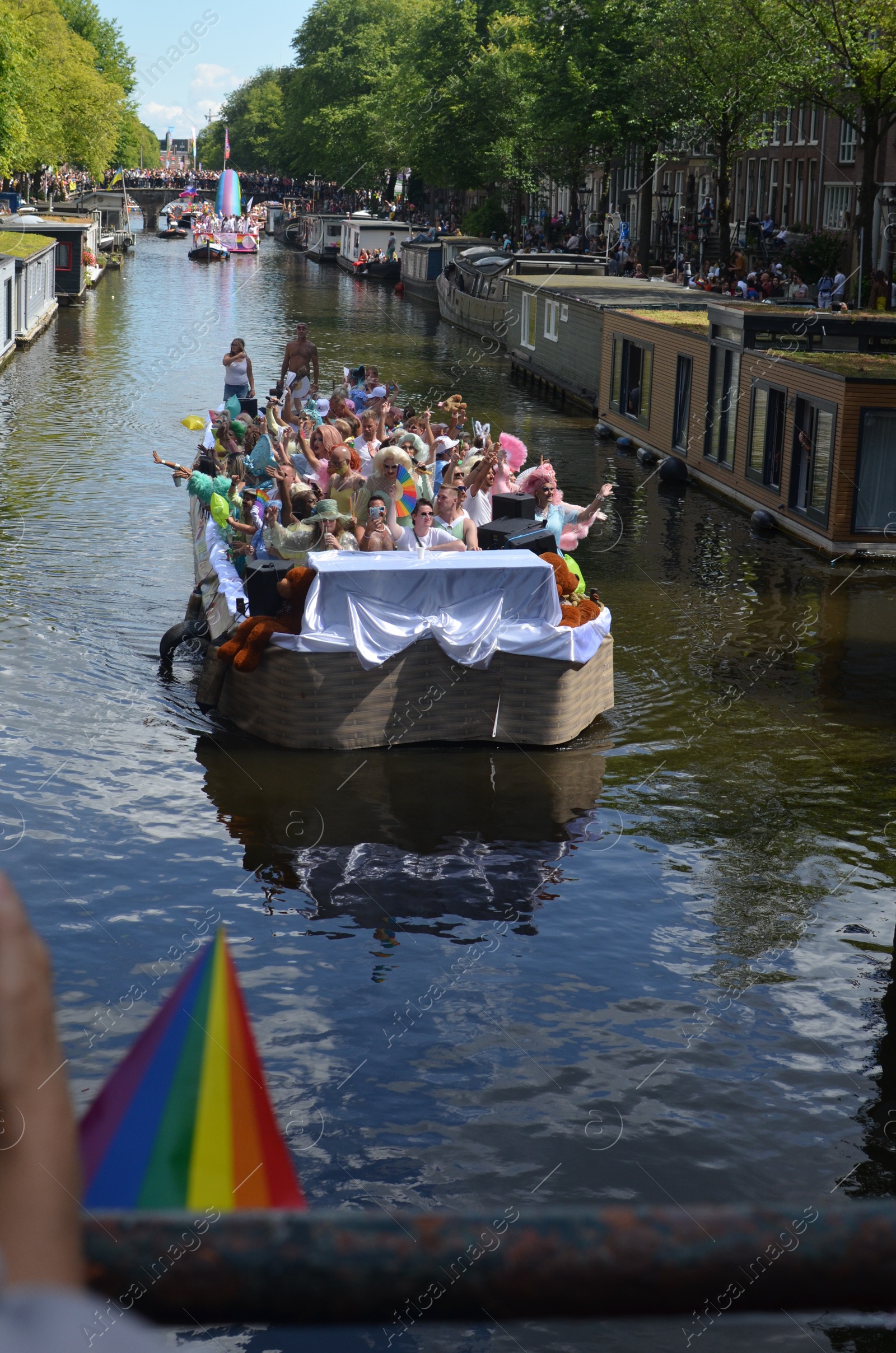 Photo of AMSTERDAM, NETHERLANDS - AUGUST 06, 2022: Many people in boat at LGBT pride parade on river