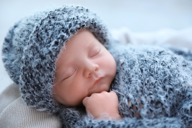 Photo of Cute newborn baby sleeping on plaid, closeup