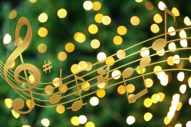 Image of Music notes on blurred background, bokeh effect. Christmas and New Year melody