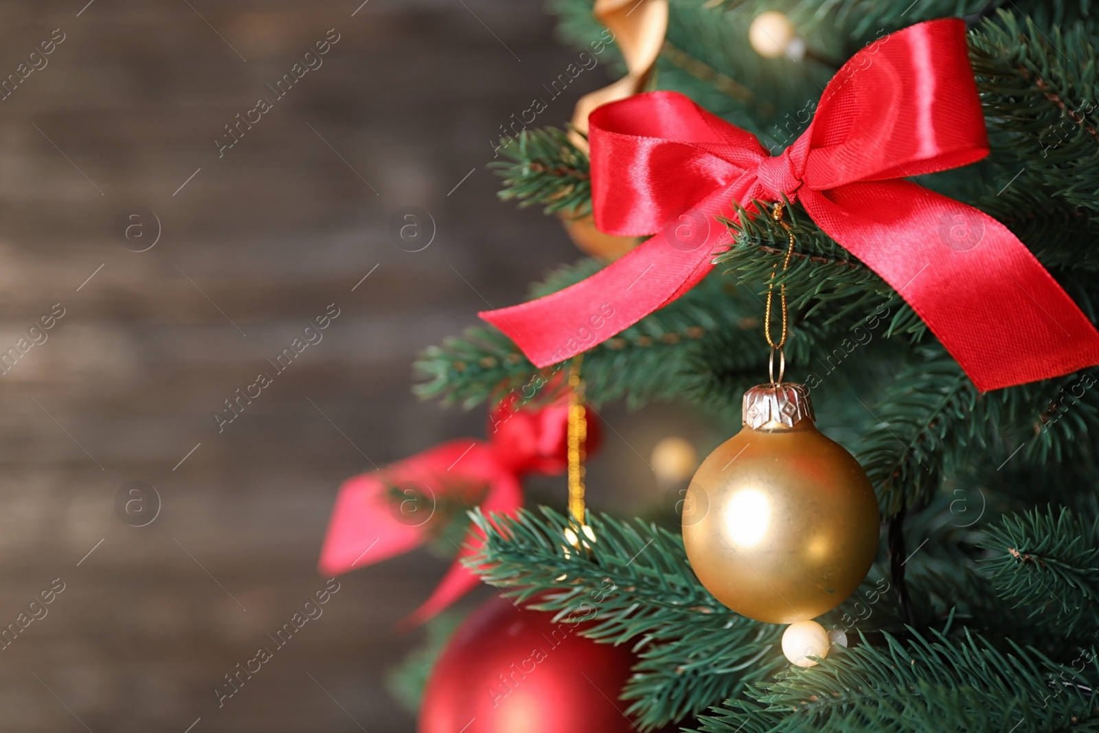 Photo of Beautiful Christmas tree with festive decor on dark background. Space for text