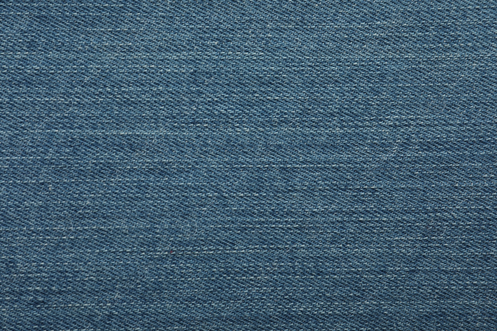 Photo of Texture of blue jeans as background, closeup