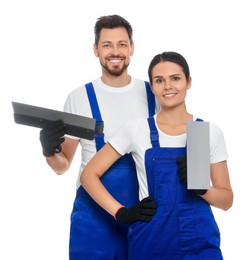 Photo of Professional workers in uniform with putty knives on white background