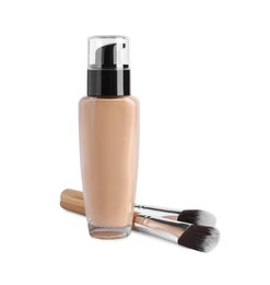 Photo of Bottle of skin foundation and brushes on white background. Makeup product
