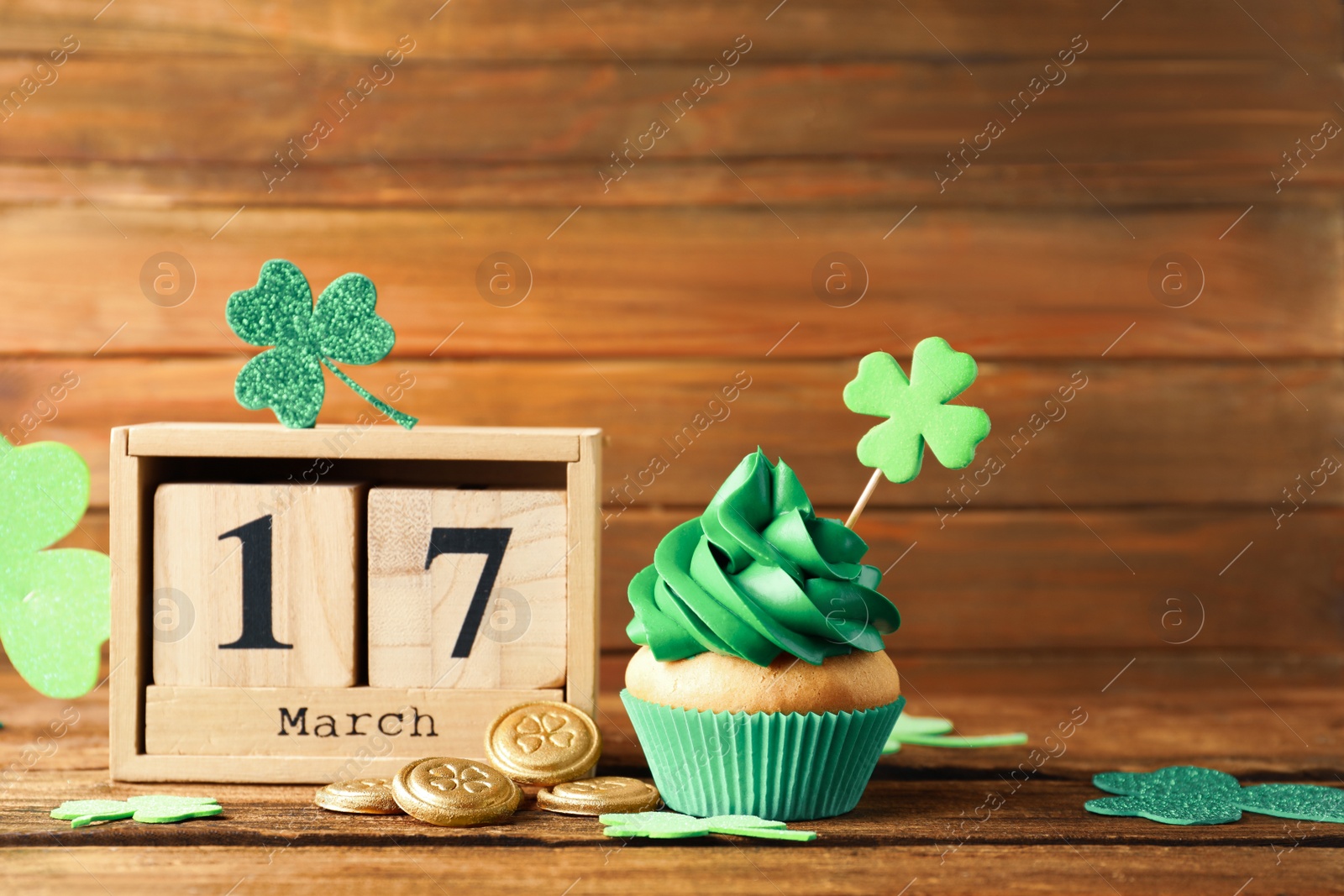 Photo of Composition with block calendar on wooden table. St. Patrick's Day celebration