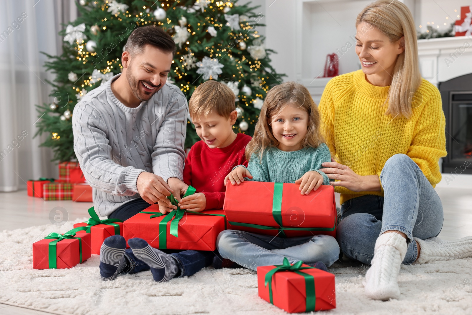 Photo of Happy family with Christmas gifts at home