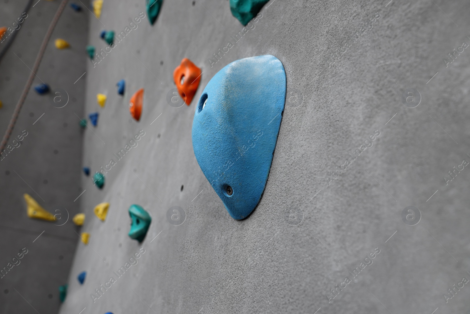 Photo of Climbing wall with holds in gym. Extreme sport