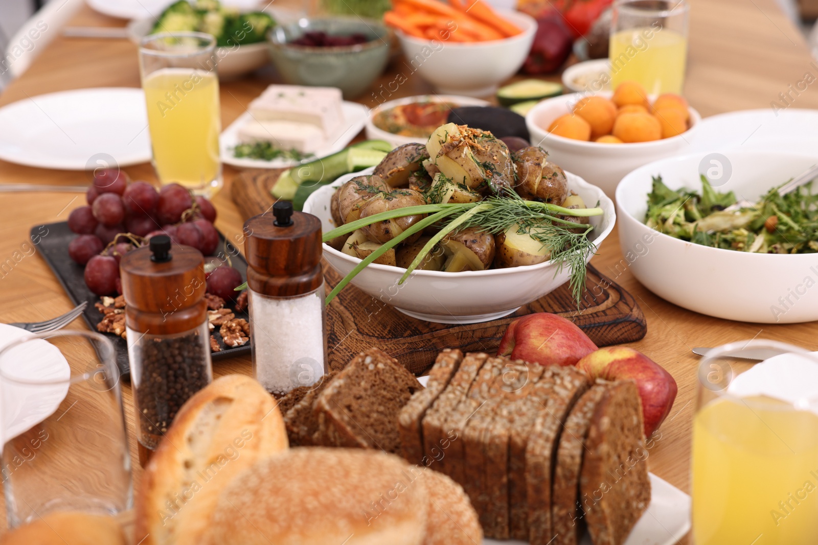 Photo of Healthy vegetarian food and glasses of juice on wooden table