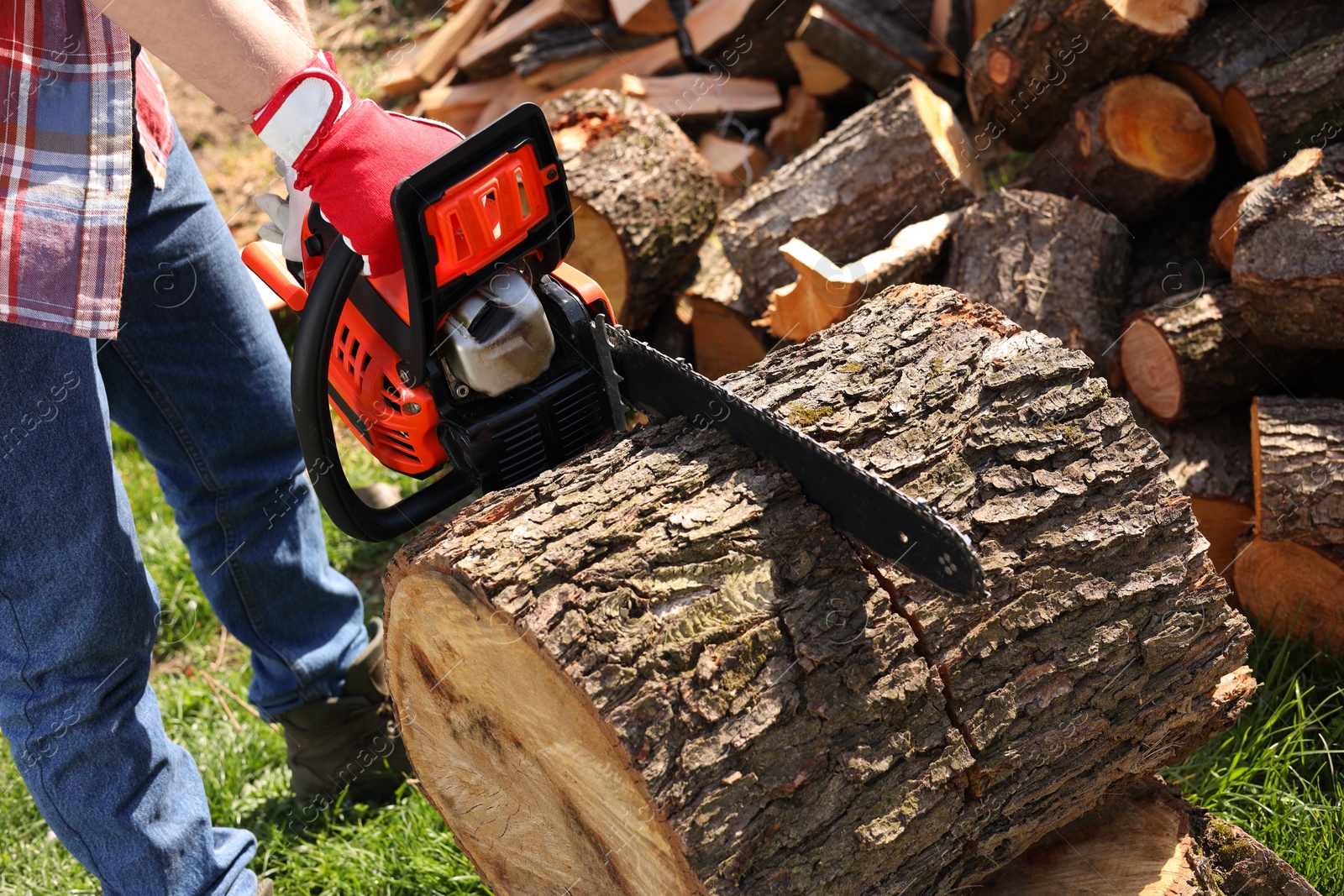 Photo of Man sawing wooden log on sunny day, closeup