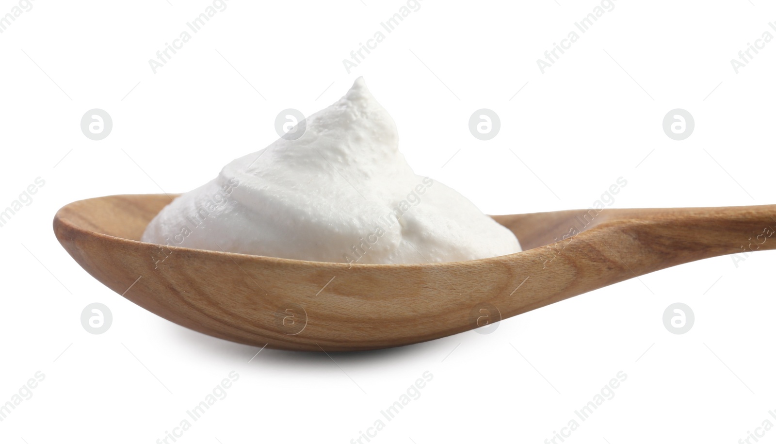 Photo of Wooden spoon with sour cream isolated on white