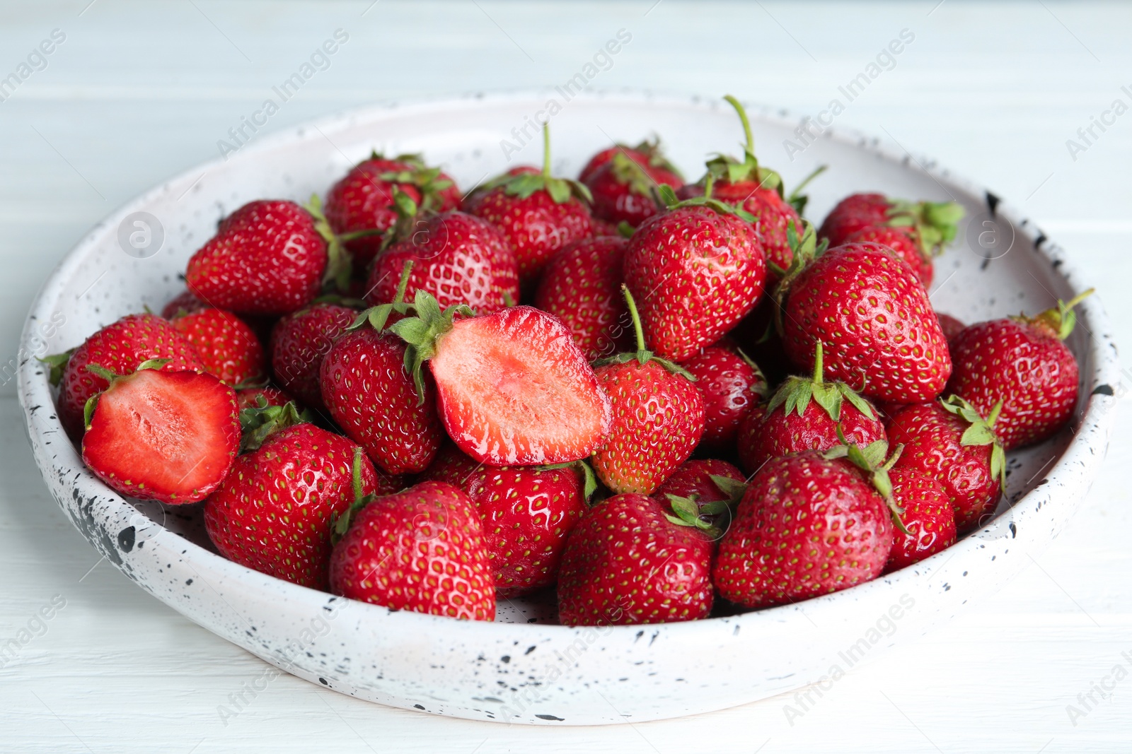 Photo of Delicious ripe strawberries on white plate, closeup