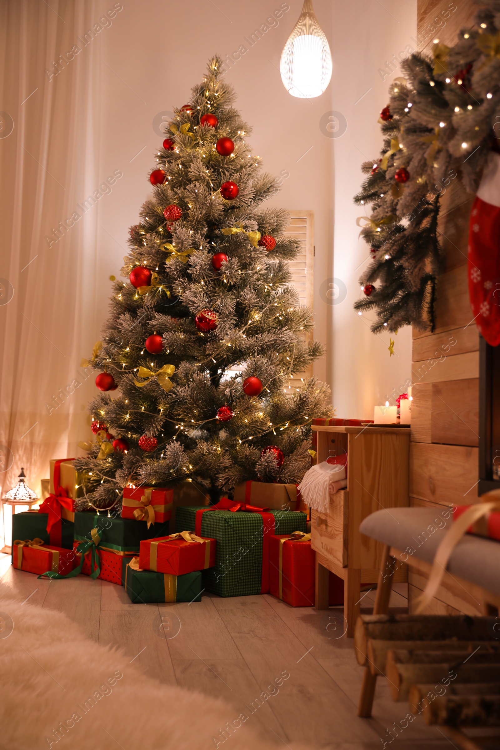 Photo of Stylish room interior with beautiful Christmas tree and gift boxes