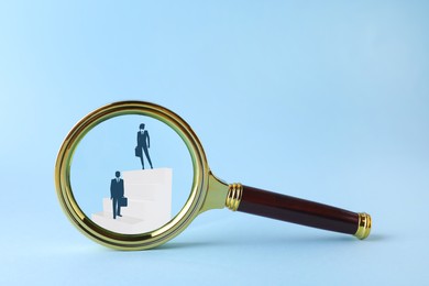 Illustration of businesspeople on steps on light blue background, view through magnifier