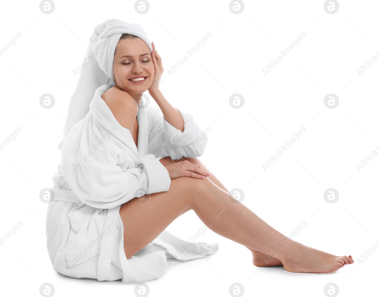 Photo of Young woman in bathrobe on white background