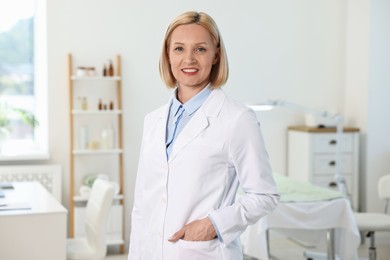 Photo of Portrait of happy dermatologist in modern clinic