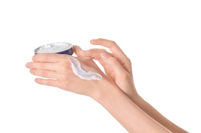 Photo of Young woman applying cream onto her hands on white background, closeup