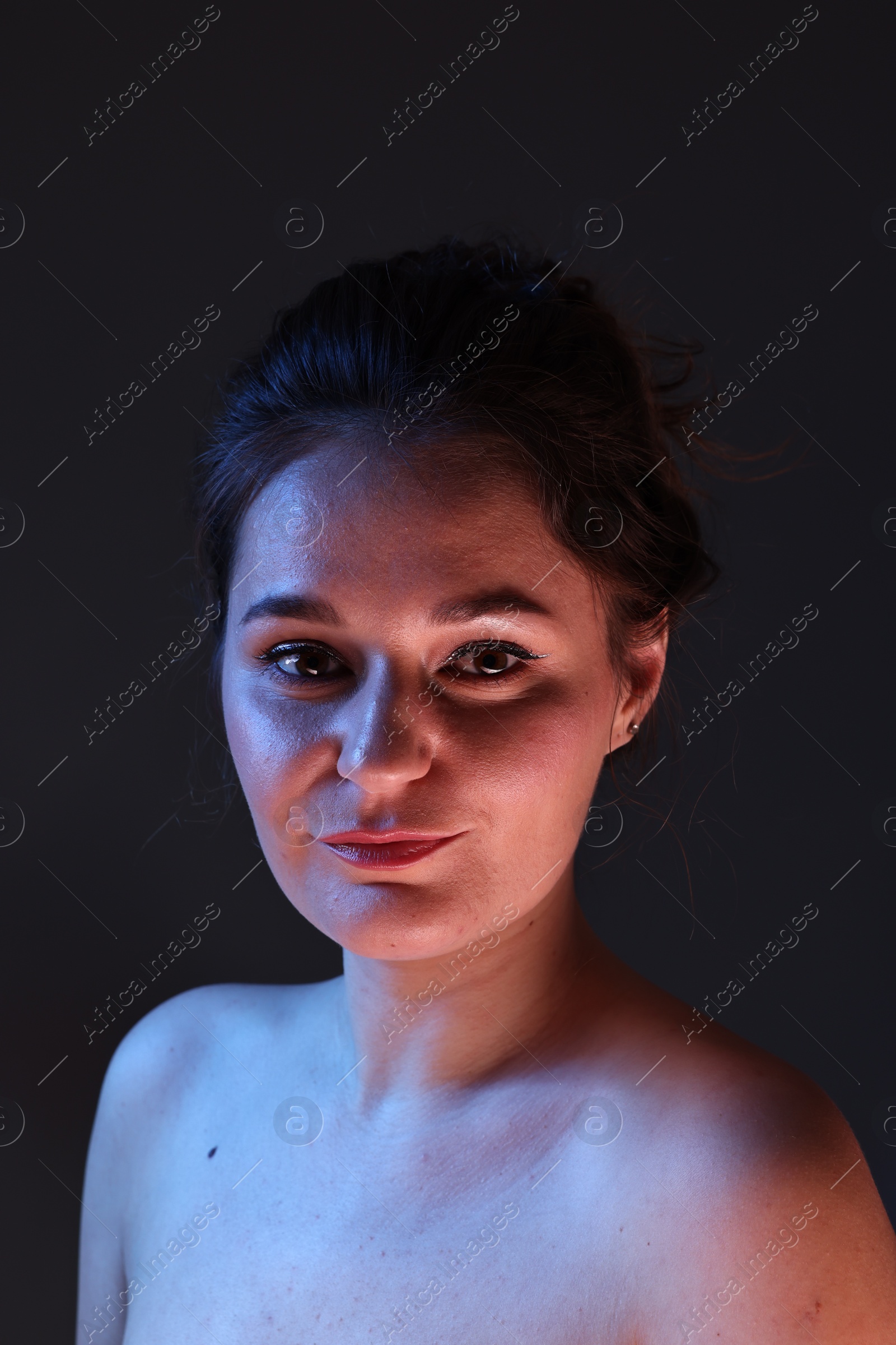 Photo of Portrait of beautiful young woman on dark background