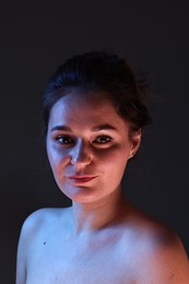 Photo of Portrait of beautiful young woman on dark background