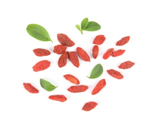 Tasty dried goji berries and leaves on white background, top view