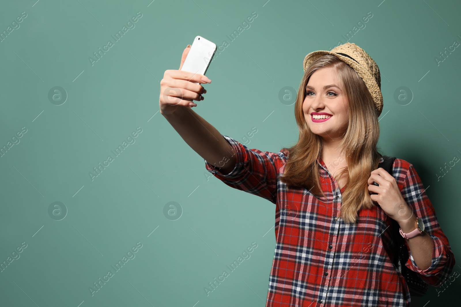 Photo of Attractive young woman taking selfie on color background