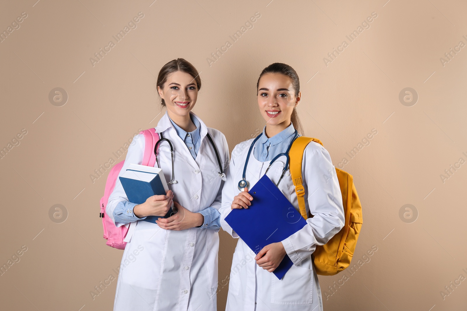 Photo of Happy young medical students on color background