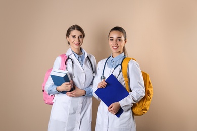 Photo of Happy young medical students on color background