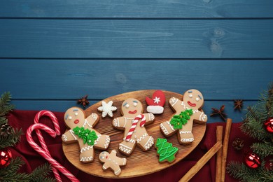 Photo of Flat lay composition with delicious Christmas cookies on blue wooden table, space for text