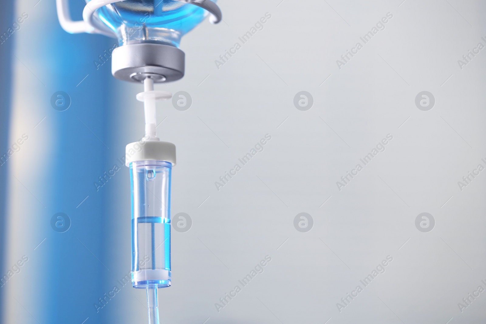 Photo of IV drip against blurred background, space for text