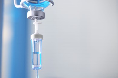 Photo of IV drip against blurred background, space for text