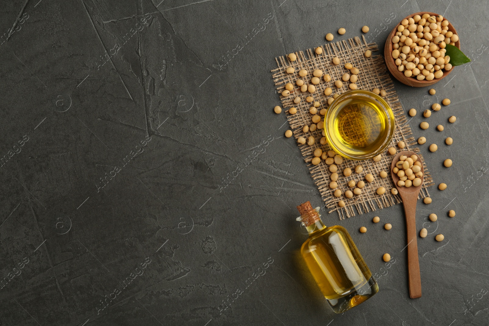 Photo of Flat lay composition with soybean oil on grey table. Space for text