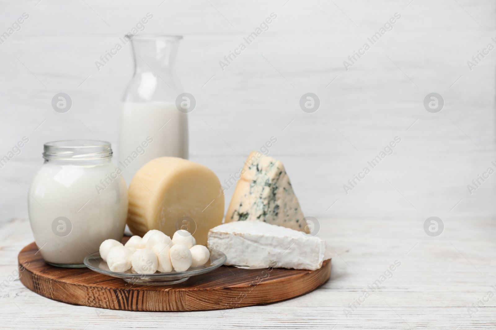 Photo of Different dairy products on wooden table