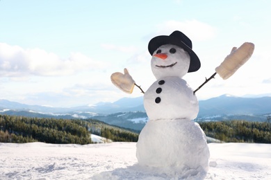 Image of Funny snowman outdoors on sunny day, space for text