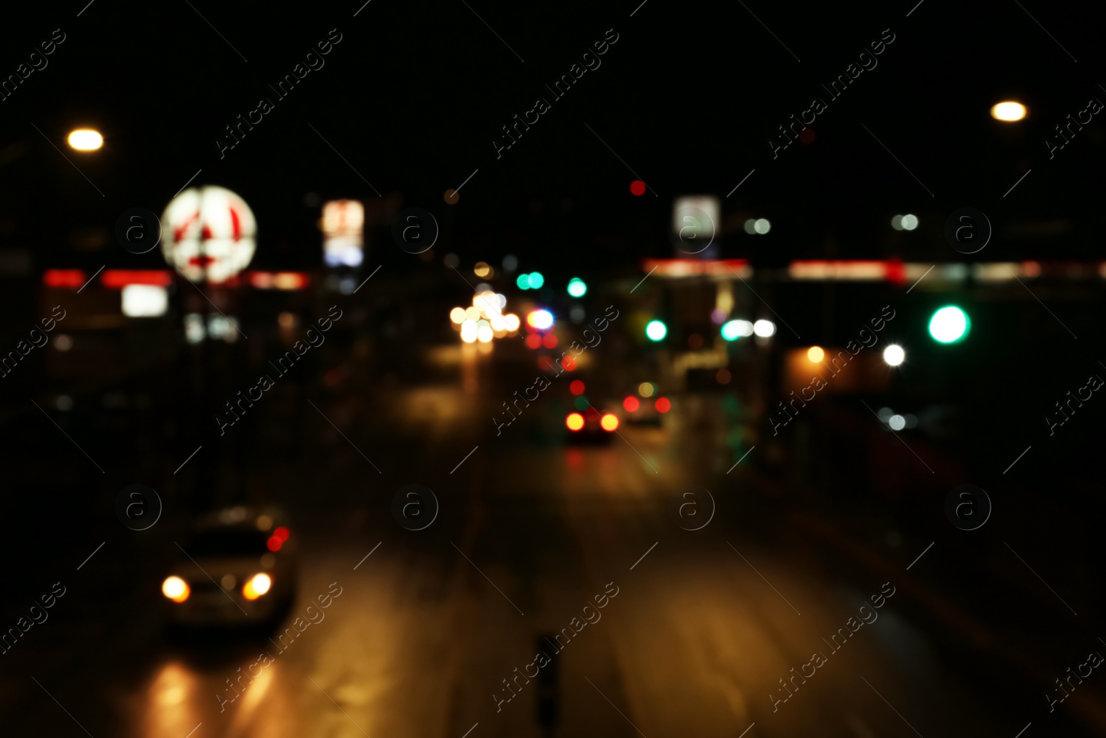 Photo of Blurred view of road with cars at night. Bokeh effect