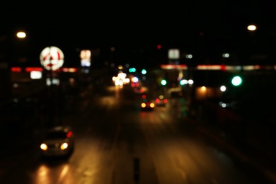 Photo of Blurred view of road with cars at night. Bokeh effect