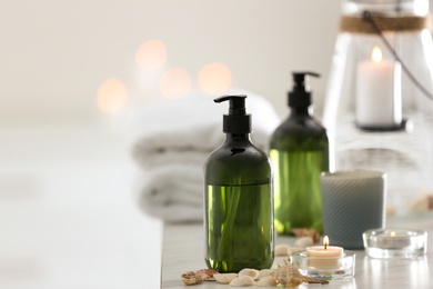 Photo of Soap dispensers and decor elements on table. Space for text