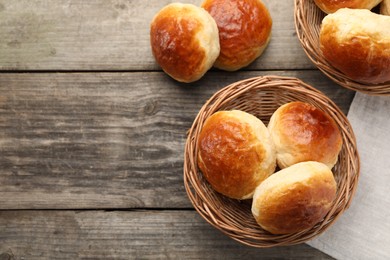 Photo of Freshly baked soda water scones on wooden table, flat lay. Space for text