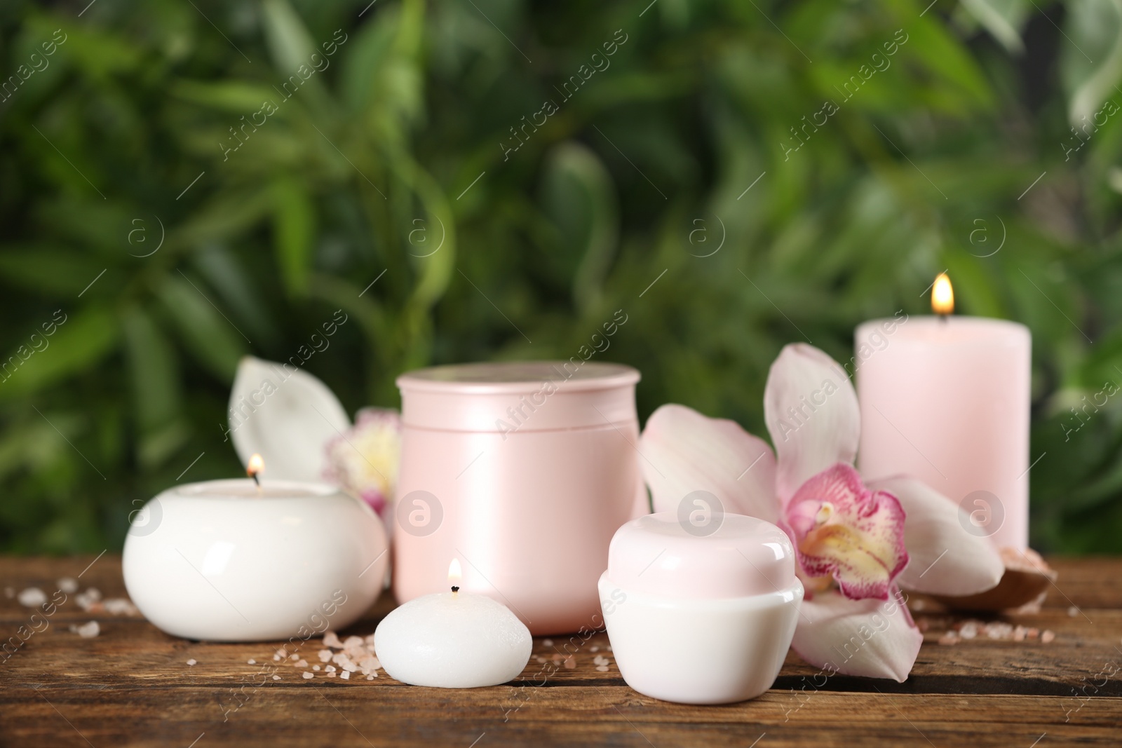 Photo of Beautiful spa composition with skin care products and candles on wooden table