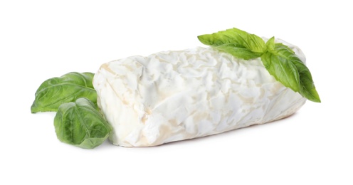 Photo of Delicious fresh goat cheese with basil on white background