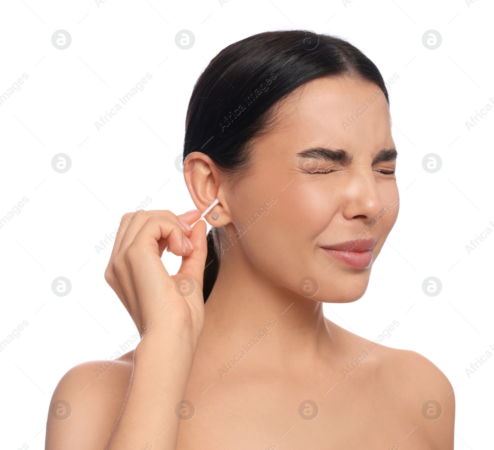 Photo of Young woman cleaning ear with cotton swab on white background