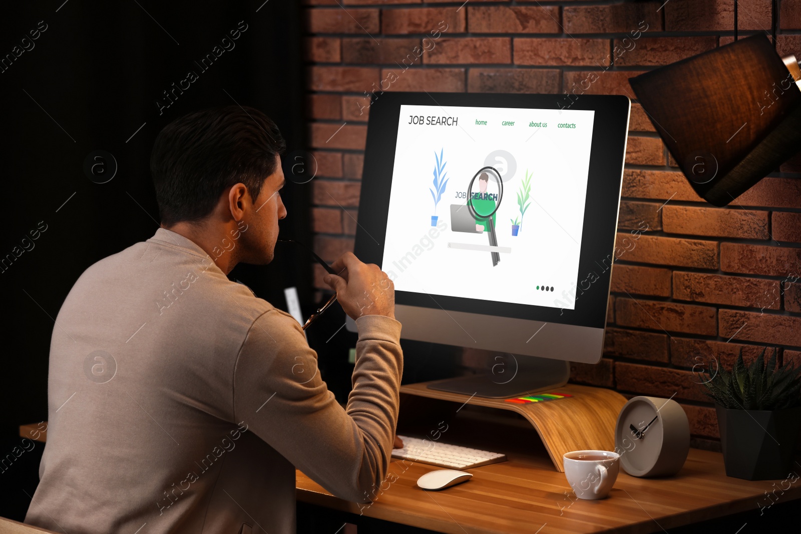 Image of Man using modern computer in office. Job search