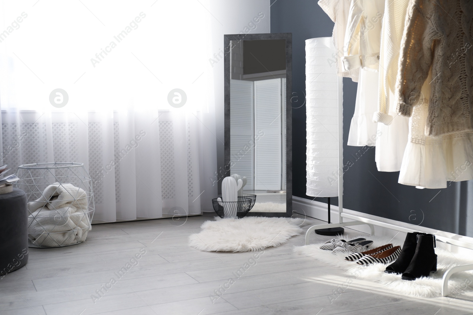 Photo of Dressing room interior with clothing rack and mirror