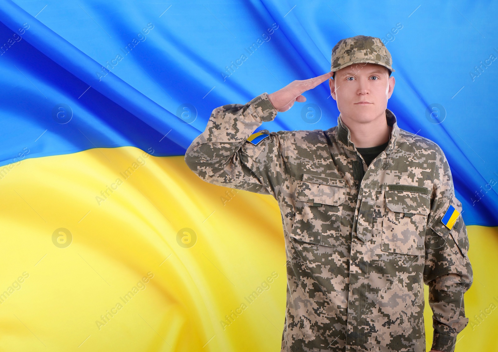 Image of Soldier in military camouflage uniform and Ukrainian flag on background, space for text. Stop war