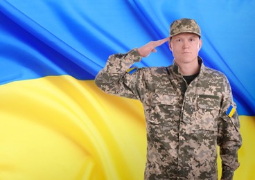 Image of Soldier in military camouflage uniform and Ukrainian flag on background, space for text. Stop war