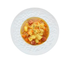 Photo of Delicious sauerkraut soup with smoked sausages and dill isolated on white, top view